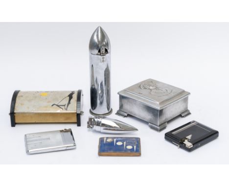 A CHROME PLATED BULLET SHAPED TABLE LIGHTER (7)The base inscribed 234-236 TATES AVENUE UM. Co LTD. BELFAST PATENTS PENDING, 2