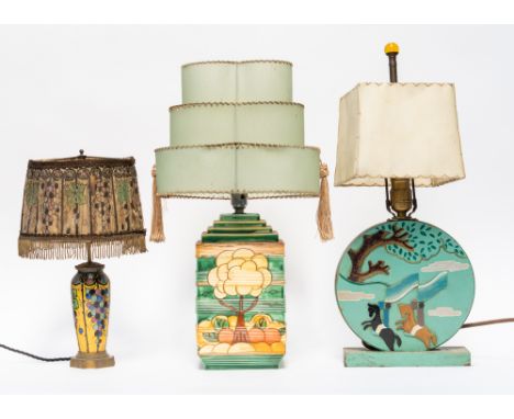 THREE TABLE LAMPS WITH SHADES INCLUDING A PAINTED RELIEF CARVED CIRCULAR LAMP (3)Depicting two horses with riders, with stitc