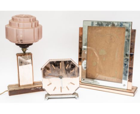 AN ART DECO PINK TINTED MIRROR GLASS PLATE MOUNTED TABLE LAMP; A MANTEL TIMEPIECE AND A FRAME (3)With pink glass shade (proba