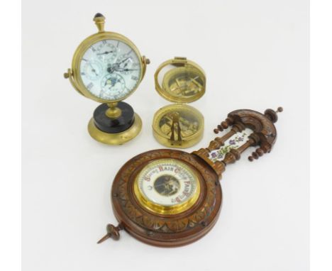 A CARVED WALNUT ANEROID BAROMETER, 44CM H, LATE 19TH C, AN ANTIQUE STYLE BRASS BULL'S EYE CLOCK AND A REPRODUCTION BRASS FOLD