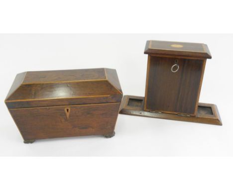 A GEORGE IV ROSEWOOD AND LINE INLAID TEA CADDY OF SARCOPHAGUS SHAPE, 29.5CM L AND AN EDWARD VII MAHOGANY AND FALL FRONT STATI