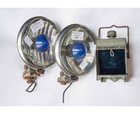 A World War II bike lamp with one circa 1970s, together with a blue spot, car, fog lamp and a circa 1970s car blue spot light