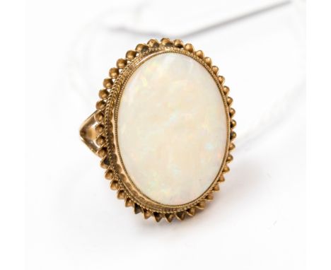 A 9 ct gold ring, size L, set with a large fire opal, length 20 mm approx., width 15 mm approx., oval shape  