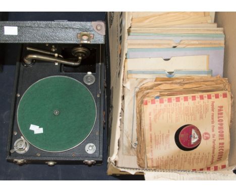 A box of vinyl records, many 78s with a portable record player  with winder and spare needles  