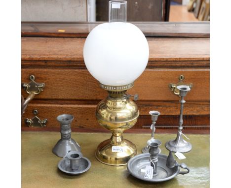 A pewter chambersticks and candlesticks etc to include a brass plated working oil lamp and globe/funnel 