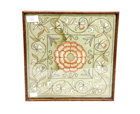 An embroidered textile sampler, possibly 18th Century, on silk, framed
