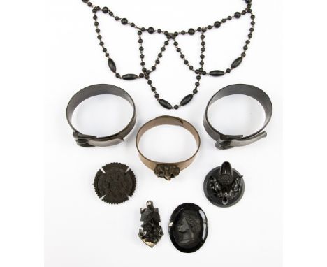 A jet bracelet, central panel of a carved acorn, together with four items of imitation jet, to include, a cameo plaque, an ar