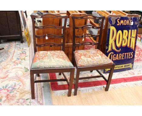 A pair of early 20th Century Chippendale style mahogany side chairs of ladder back form, (2)