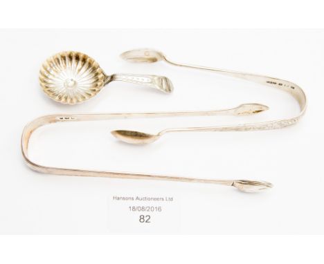 A George III silver caddy spoon, Birmingham 1796, 0.25 ozt, a pair of George III silver sugar tongs, and a later pair, 1.81 o