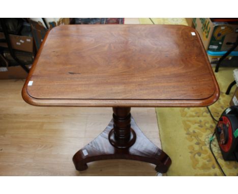 A George IV mahogany tilt-top tripod table, the square top raised on a turned column, standing on a triform base with scroll 