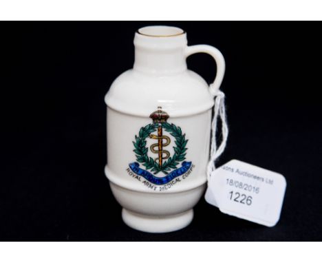 A WWI Goss Army Medical Corps crest, the model of a jug in Kendal museum (1802)