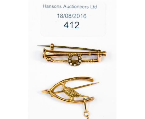 Hunting theme: two 9ct. gold brooches, comprising hunting horn, whip and seed pearl horseshoe and pheasant and wishbone (a/f)