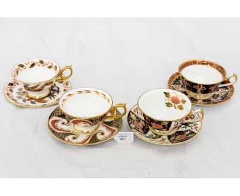 A Harlequin set of four Royal Crown Derby tea cups and saucers 