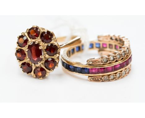 A sapphire, ruby and white sapphire, rose and yellow gold ring, the centre shank calibre set half rubies and half sapphires, 