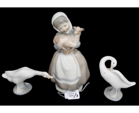 Two Lladro geese and a Nao figurine of a girl with lamb 