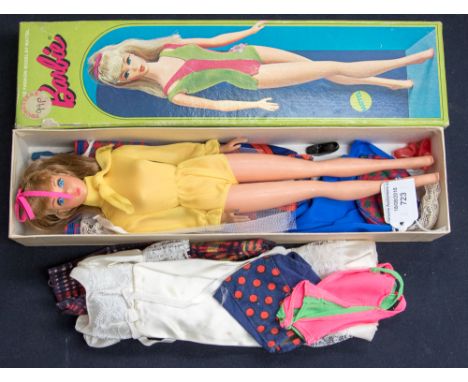 A boxed Mattel Barbi with collection of clothes