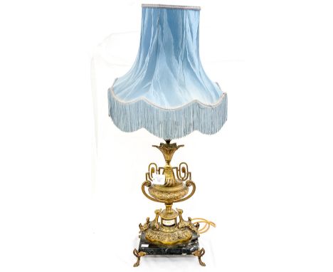 A late 20th Century gilt metal lamp, raised on a marble base, standing on scrolled feet, approx. 86 cm high