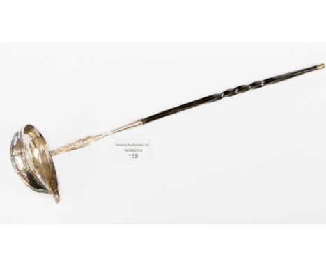 A George III white metal punch ladle, with a whale bone handle, inset with a coin, dated 1785