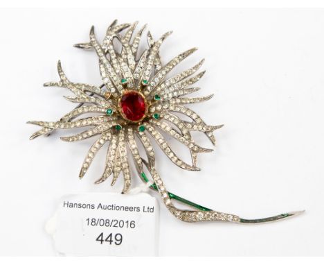 A Christian Dior brooch, named disc to back dated 1960, a fluid daisy with central red paste stone and green stamen paste sto