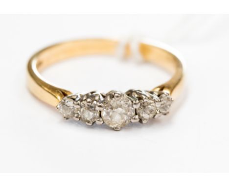 An 18 ct gold ring, set with five (tested) diamonds, approx. ring size R