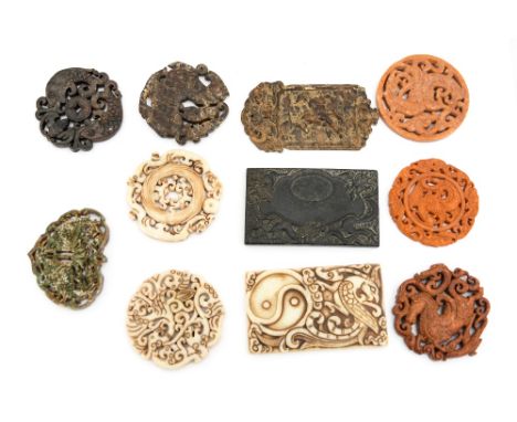 A collection of carved stone Chinese plaques and pendants, various stones, probably including jade 