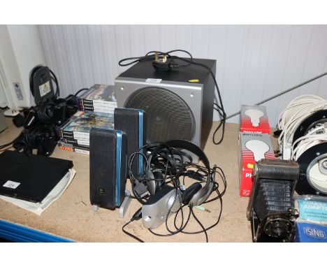 A sub speaker, two Logitech speakers and headset