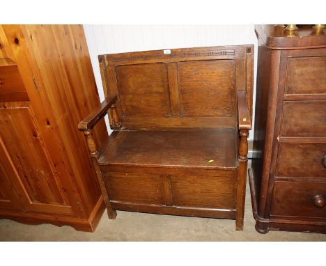 An oak monks bench with under seat storage