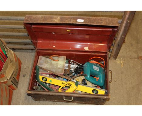 A metal dome topped trunk and contents of tools to include a Black & Decker jigsaw; camera tripods; spirit level; hand saw; b