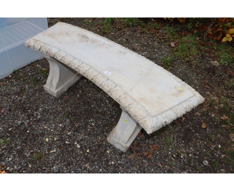 A concrete garden bench raised on two plinths AF