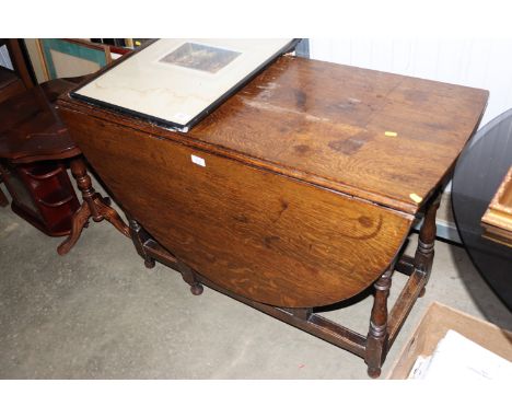 An antique oak gate leg table