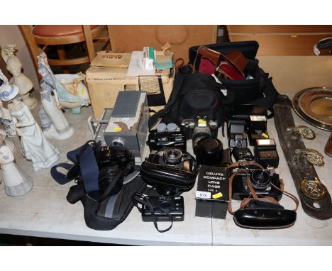 A large quantity of various cameras and slid projector to include Pentax, Olympus, Canon etc