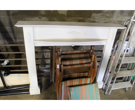 A white painted wooden fire surround