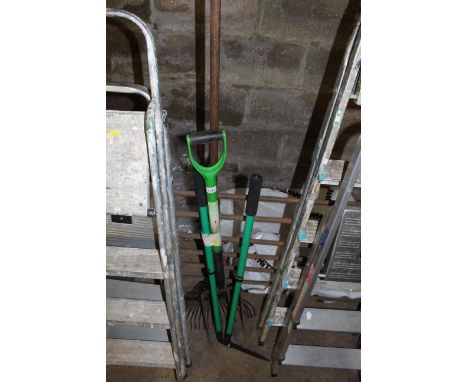 A bundle of gardening  tools to include rake, digging fork, garden shears