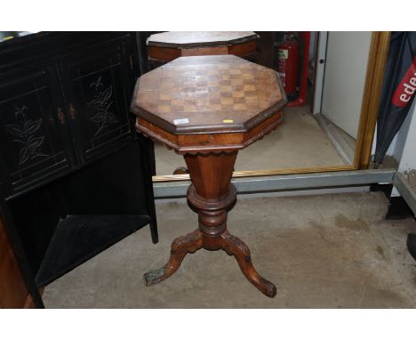 A Victorian walnut trumpet sewing table and games board top raised on tripod base AF