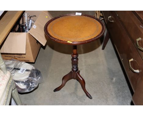 A mahogany wine table raised on tripod base