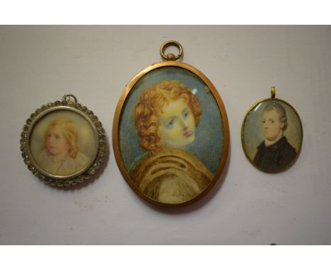 A SMALL MINIATURE PORTRAIT OF A YOUNG CHILD, tondo, in circular white metal and jewelled pendant, 1.75" (5cm); together with 