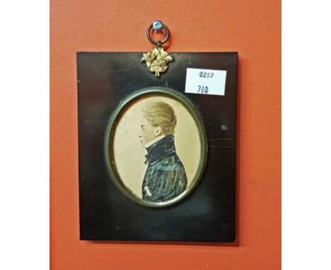 NINETEENTH CENTURY ENGLISH SCHOOL, oval miniature profile portrait of a military officer in black uniform with dagger, W.C., 