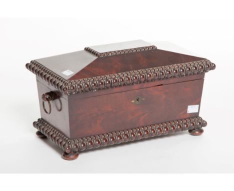 A LATE WILLIAM IV PERIOD MAHOGANY TEA CADDY, of sarcophagus form, applied with two brass ring handles, the top opening to rev