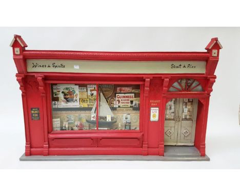 A VERY UNUSUAL SCALE MODEL OF A RED COLOURED PUB FRONT, the sign inscribed Wines & Spirits, Stouts & Ales, the large window w