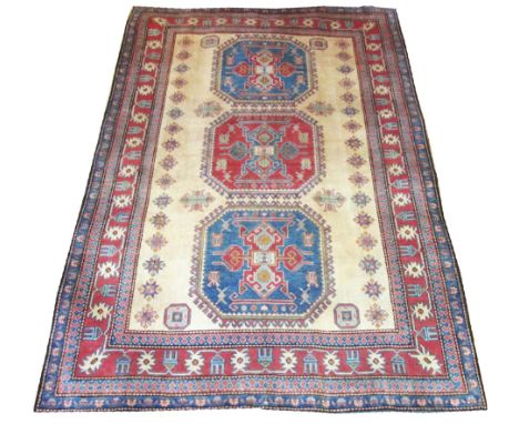 KAZAK CARPET, 254cm x 174cm, Karachov design, repeat octagonal medallions on ivory field framed by repeat stars and other sca