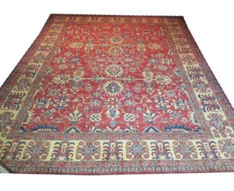 LARGE KAZAK CARPET, 510cm x 410cm, all over design of stylised palmettes and vines on a terracotta field inside multiple corr