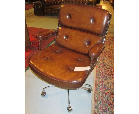 REVOLVING DESK CHAIR, Charles Eames design tan brown leather to seat revolving and reclining on an adjustable base with casto