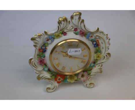 Coalport Eight day Mantle Clock with Flowers in relief and Glass cover to the Silvered dial, approx 16cm diameter