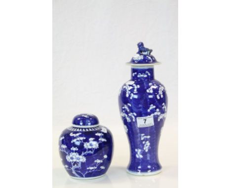 Chinese Prunus pattern ceramic Ginger jar with lid, blue circle marked to base and a similar Lidded vase with four character 