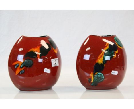 Pair of Poole Pottery vases, red ground with abstract design &amp; Dolphin logo to base, both approx 8cm tall