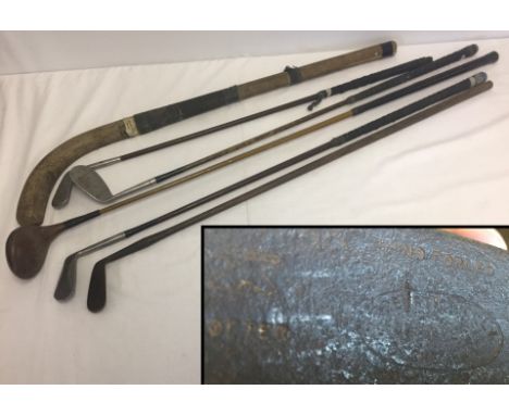 A Collection of vintage golf clubs and an early hockey stick. To include an early hand forged putter with  original hickory w
