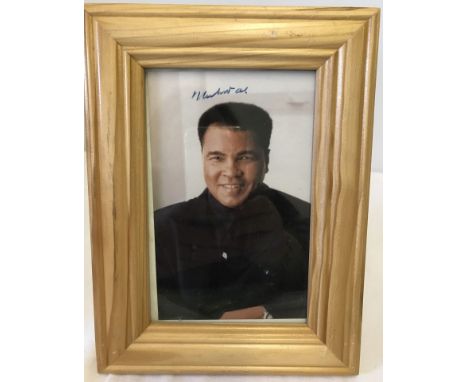 A Muhammad Ali signed small colour portrait photograph. With COA. Framed & glazed. 6 x 4 inches.