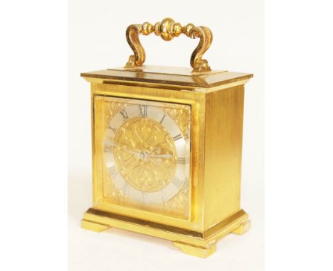 An Imhof solid brass carriage clock with brass face and chapter ring bearing roman numerals, height 24cm.  