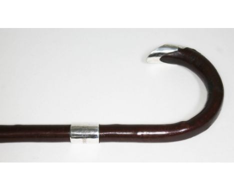 A hallmarked silver mounted walking stick, length 90cm.  