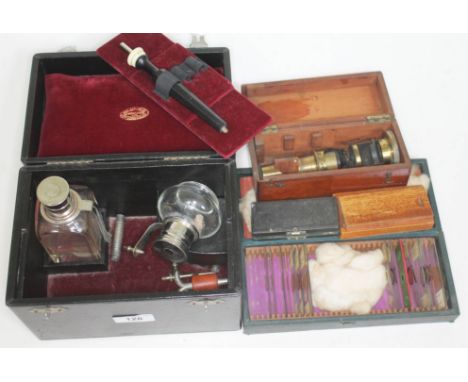 A cased portable lab equipment containing two bottles, pipes, etc. together with a boxed small microscope in wooden box and a